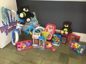 Warner Robins toy drive collection including stuffed bears, a bike, dolls and miniature cars