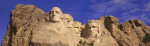 Close up view of Mount Rushmore National Monument against a blue sky