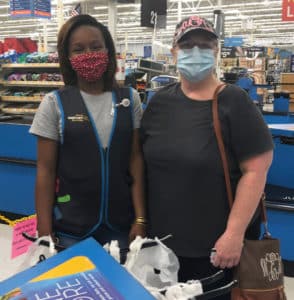 Woman standing next to Walmart employee