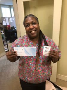 Woman holding MidSouth Act of Kindness ticket