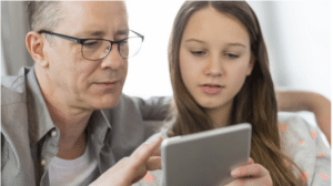Father & daughter looking at tablet