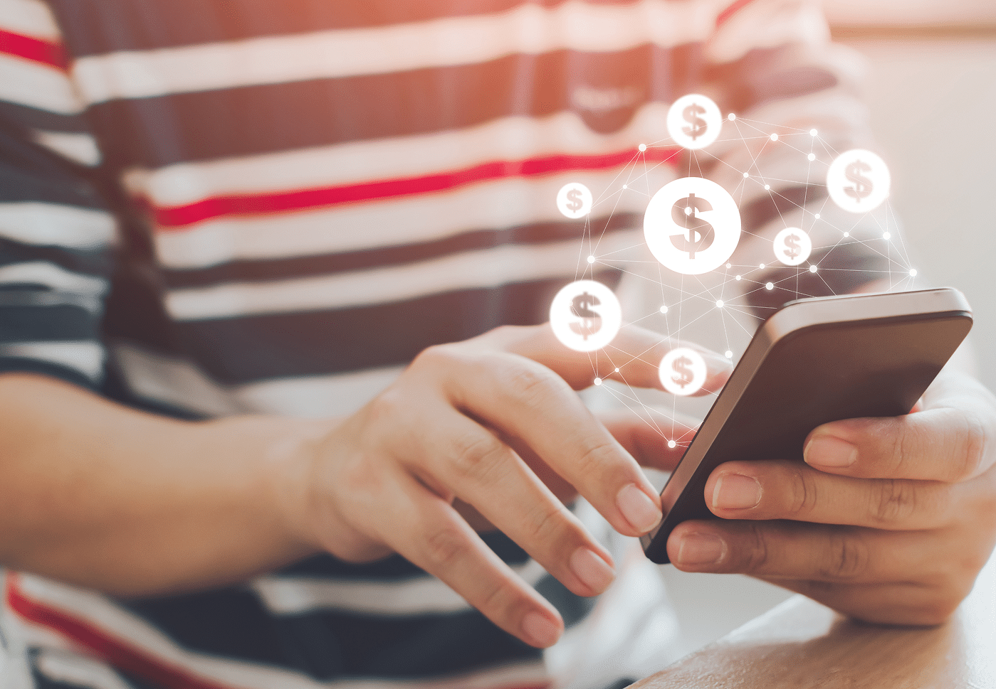 A person in a striped shirt uses a smartphone as digital dollar symbols and network lines appear above, symbolizing online banking.