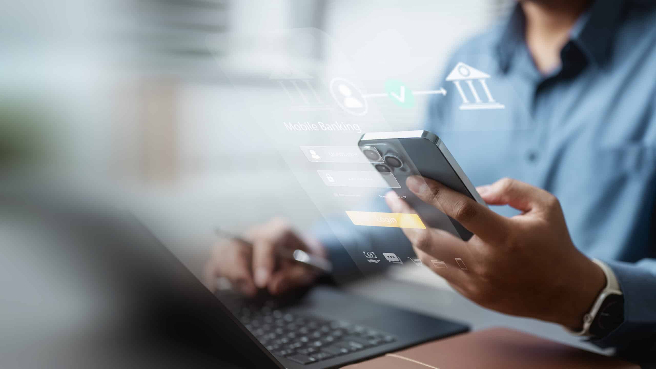 A person in a blue shirt uses a smartphone and laptop for mobile banking, with digital finance icons and login graphics overlaid.