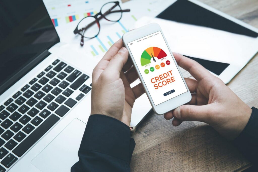 Man holding iPhone with credit score app opened