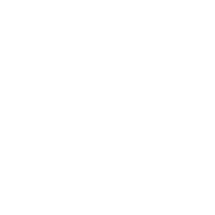 A white graduation cap with a tassel resting on a light grey background.