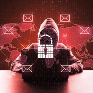A hooded individual at a computer with a padlock icon, email symbols, and a world map, symbolizing email hacking threats.